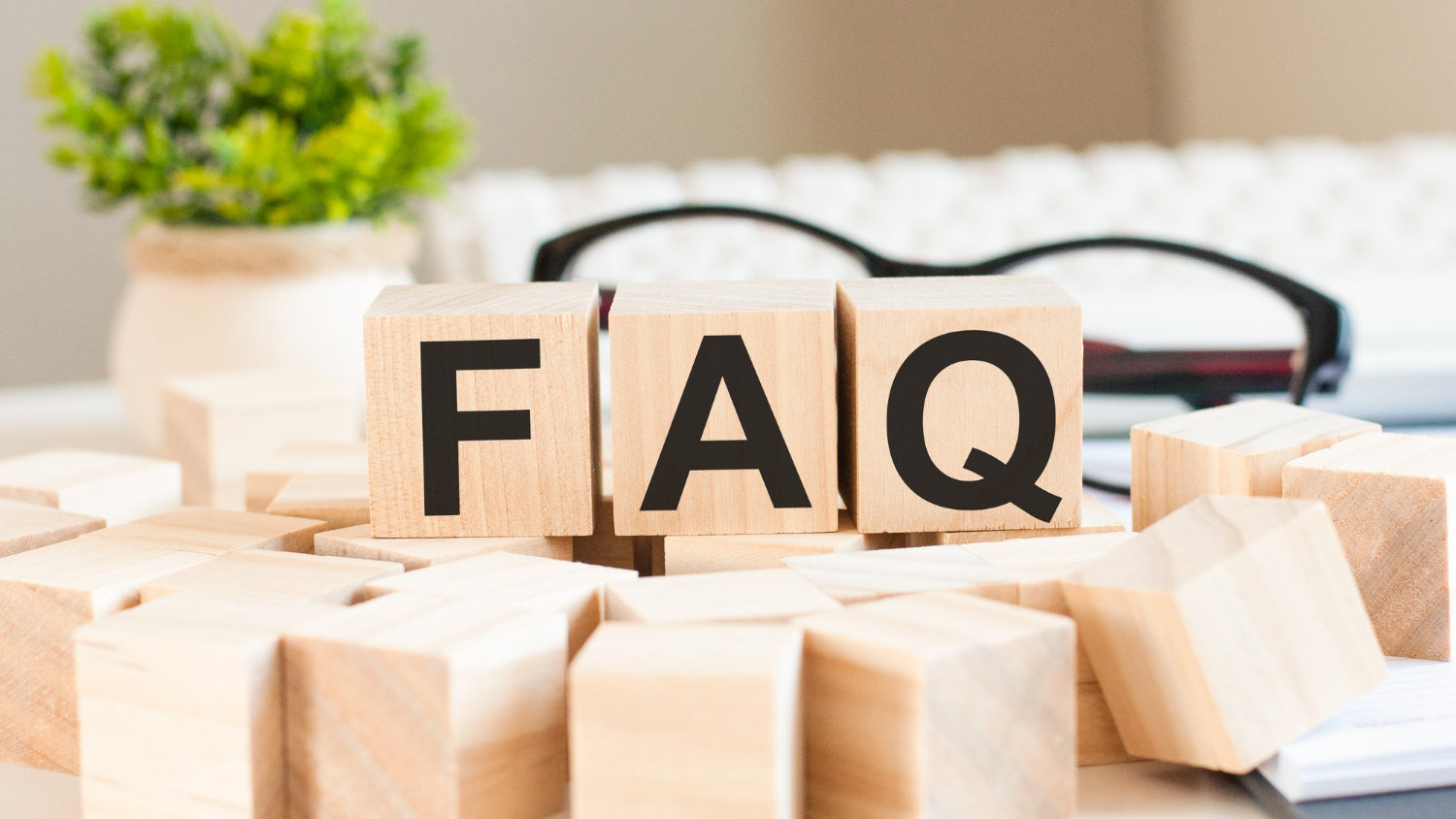 businesswoman-hand-holding-faq-word-with-wooden-cube-block